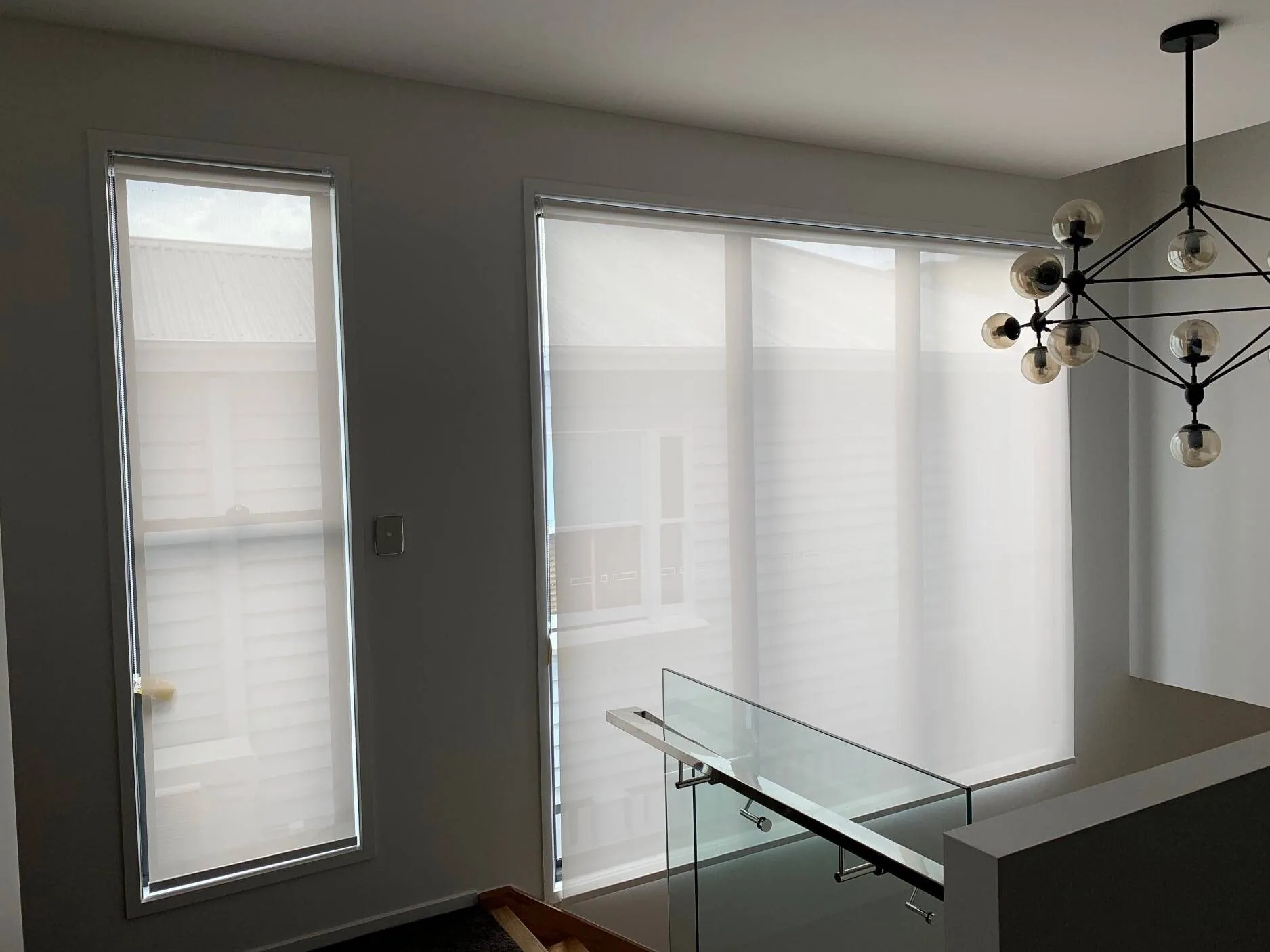 Roller blinds fitted across a run of living room windows