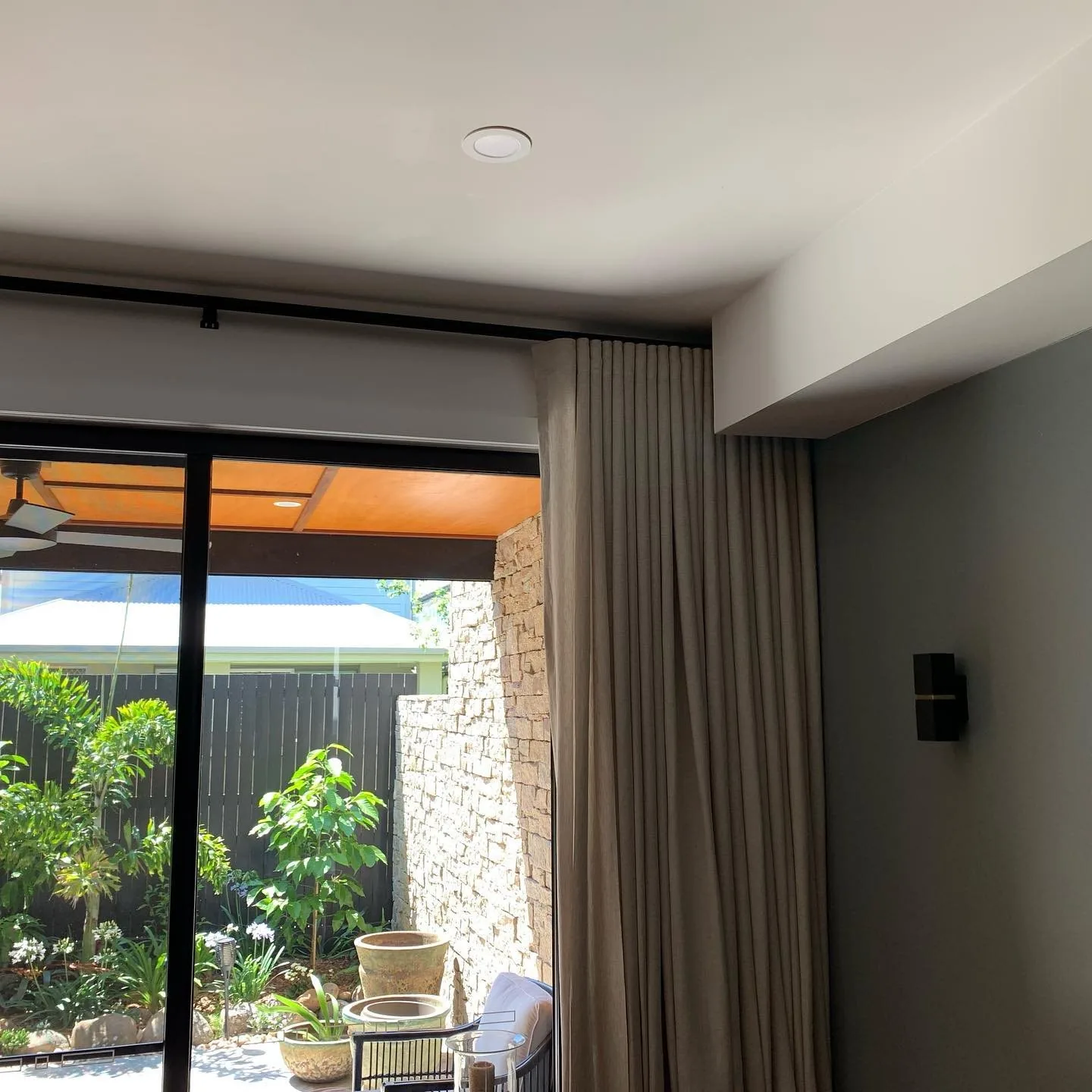 Linen curtains hanging in soft folds beside a sunlit window