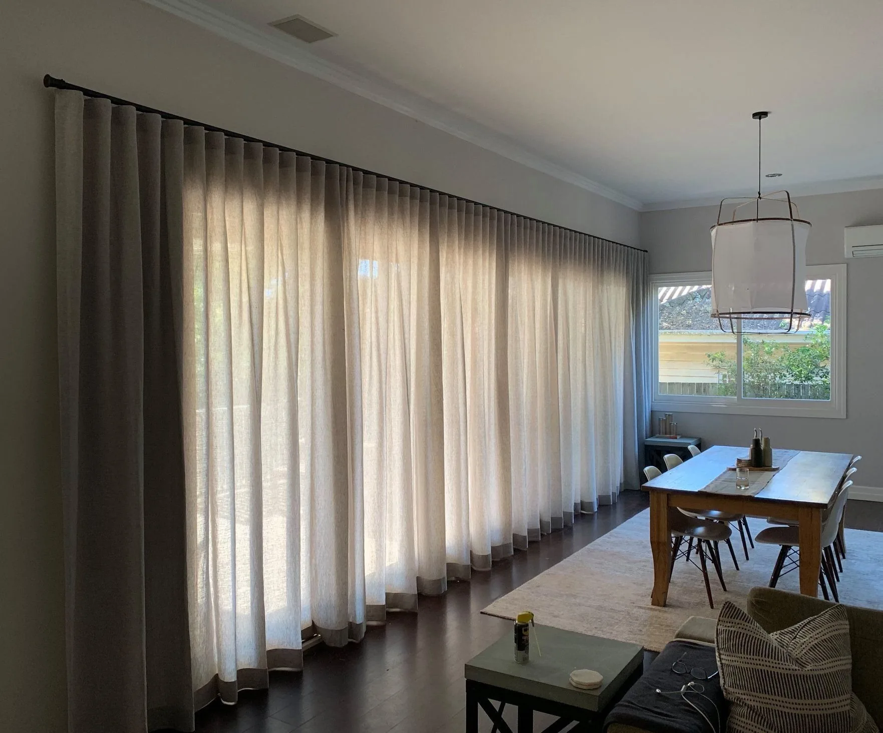 Curtains and sheers layered across a living room during an in-home consultation