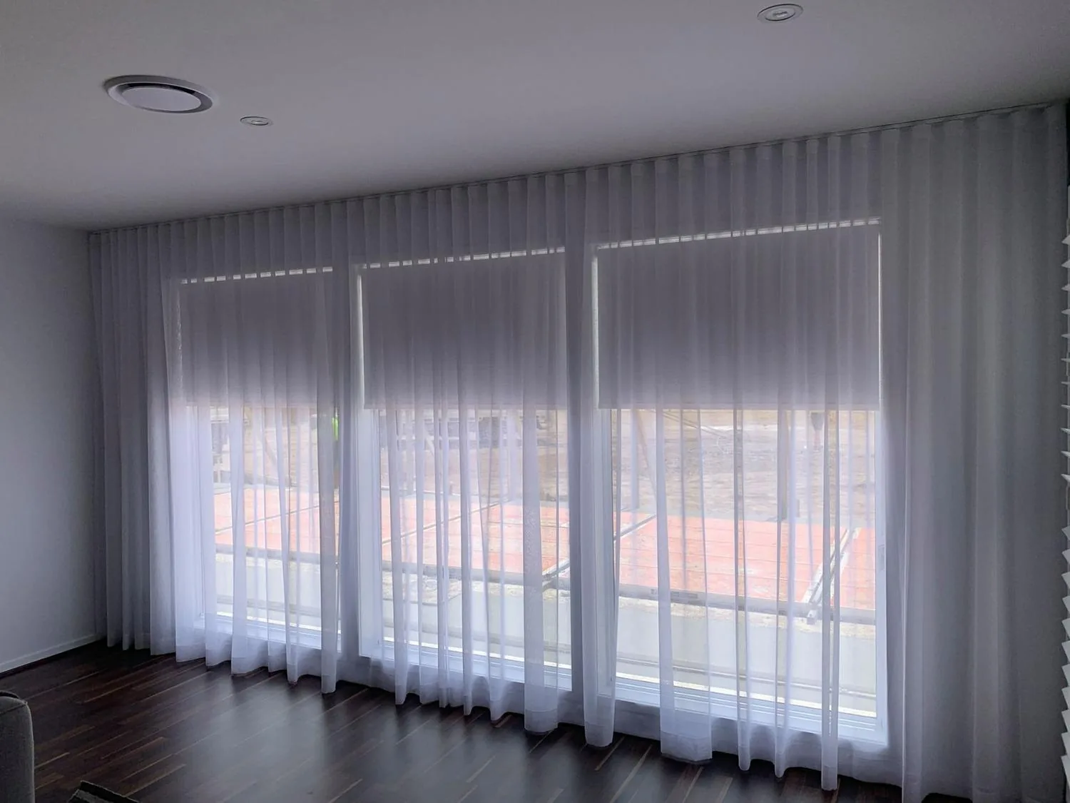 Curtains hanging full length beside a window in a Brisbane home