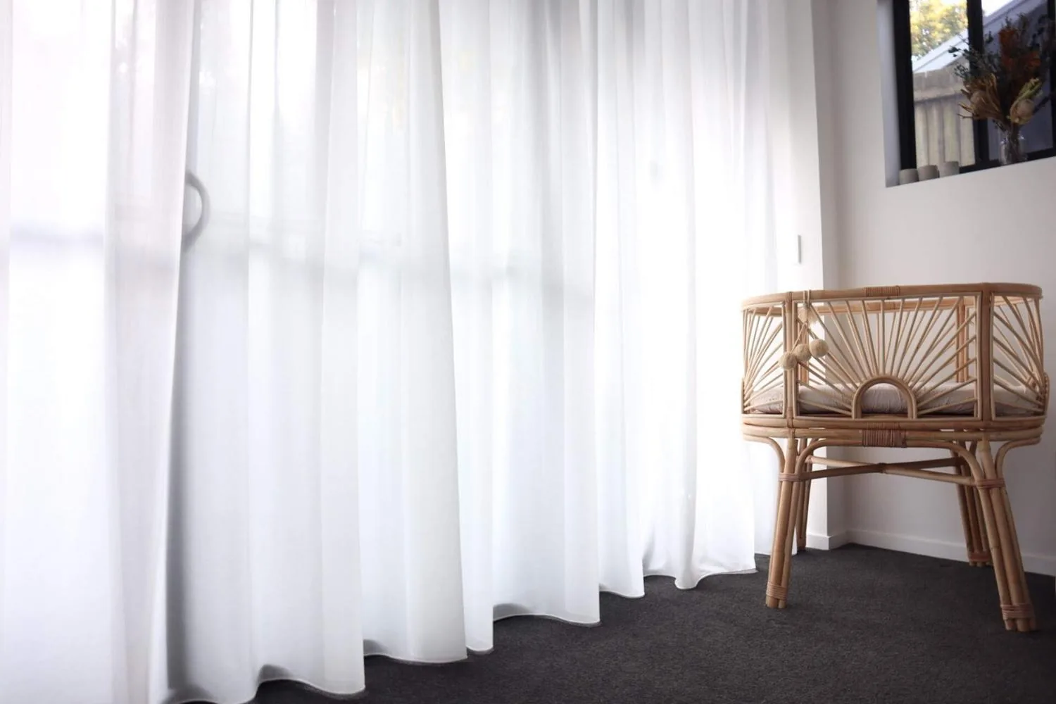 Sheer curtains drawn across a living room window in a Brisbane home