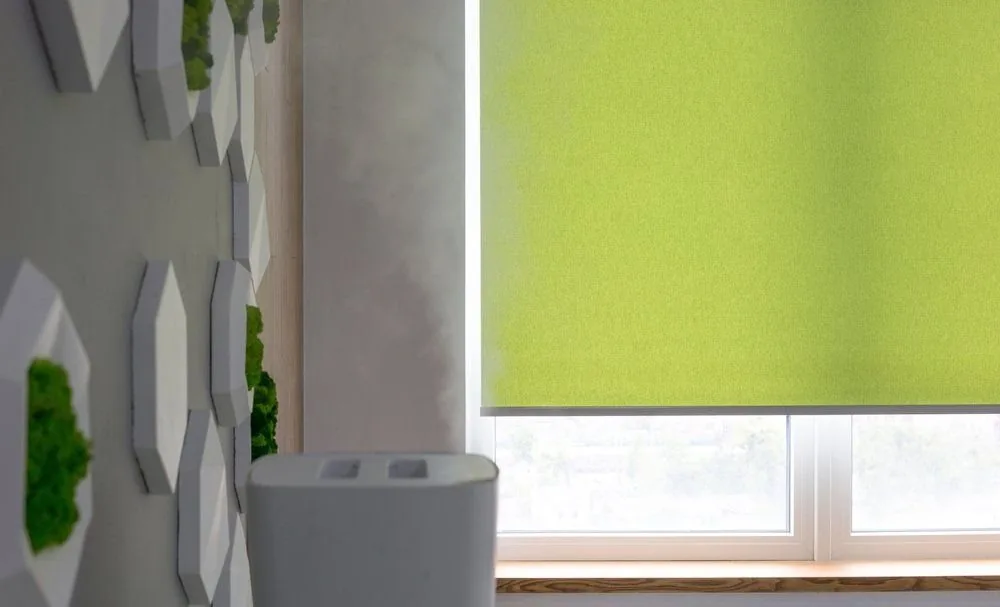 Motorised blinds part-raised across a living room window wall
