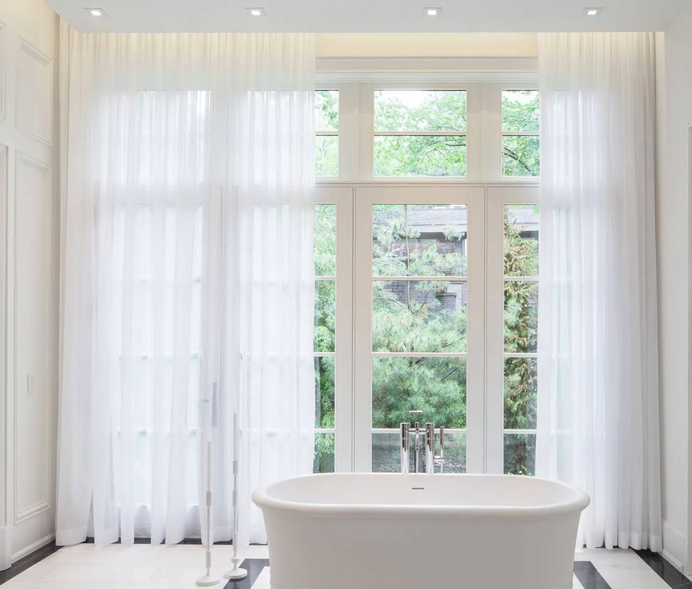 Motorised sheers running the full width of a high window wall