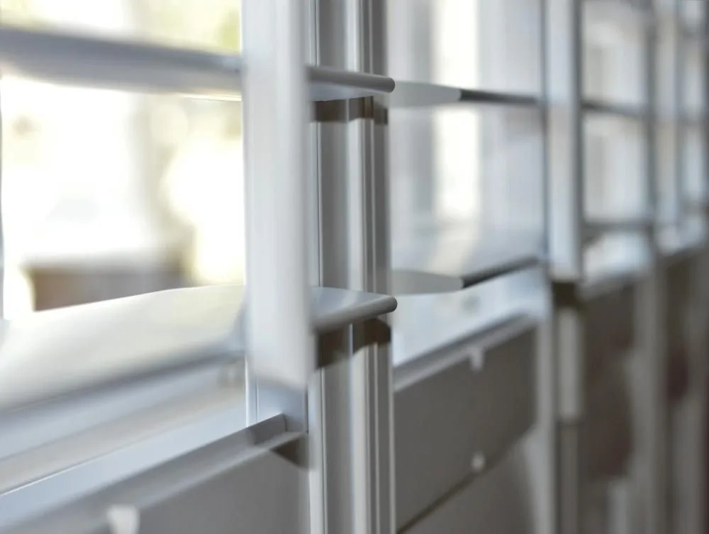 Close detail of a white plantation shutter louvre and frame