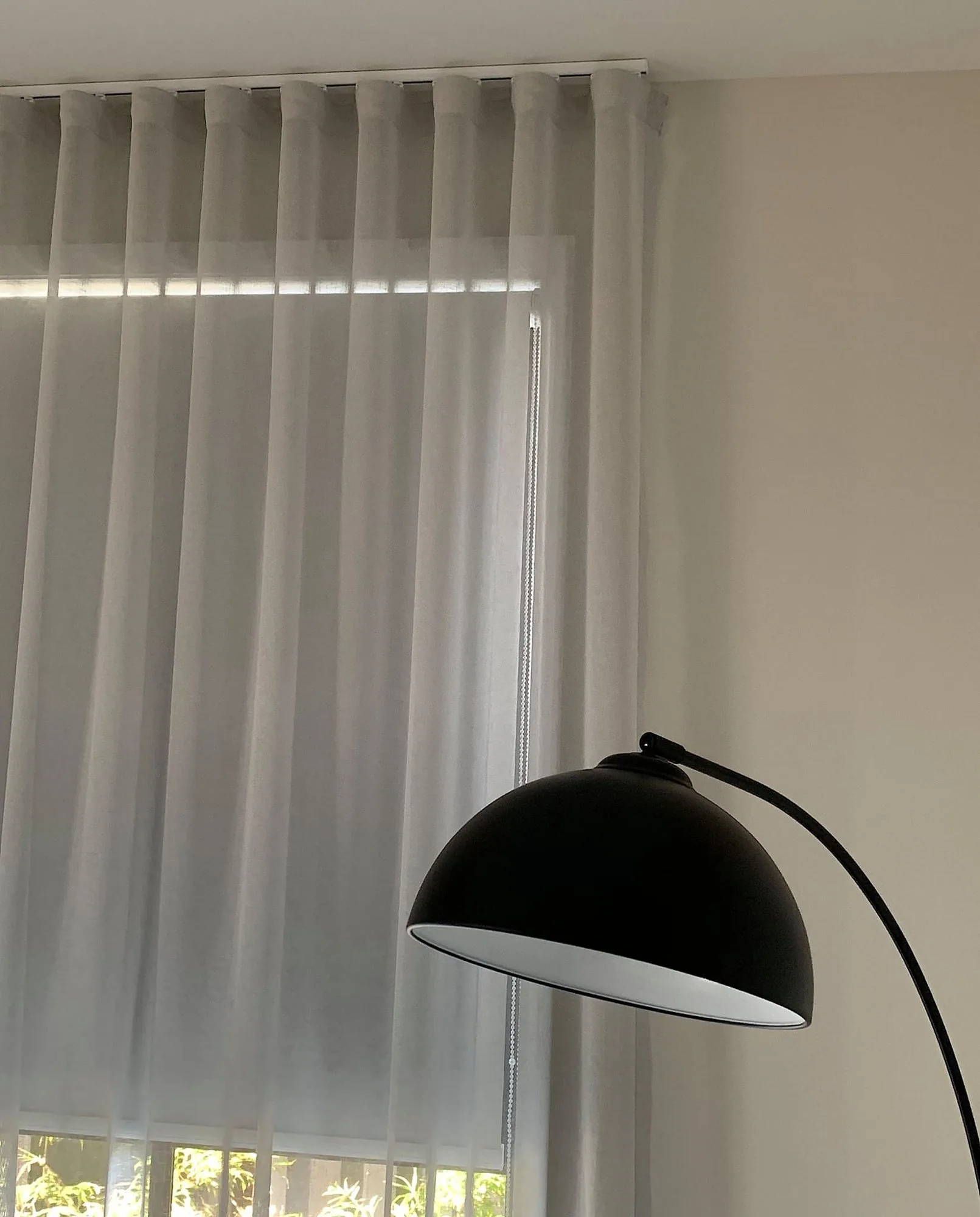 S-fold sheers running the length of a wide window wall
